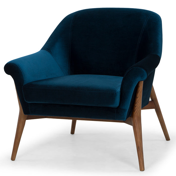 The Charlize Occasional Chair in midnight blue velvet with ash stained walnut legs