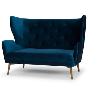 The Klara settee in midnight blue velvet with ash stained walnut legs