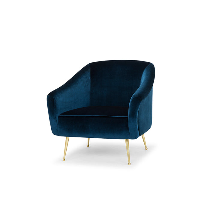 The Lucie Occasional Chair in midnight blue velvet with satin brass legs