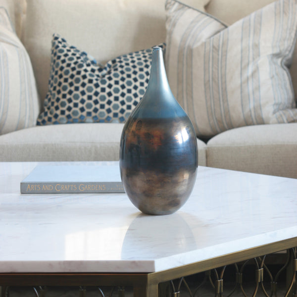 Medium iridescent glass vase in blue on hexagon table